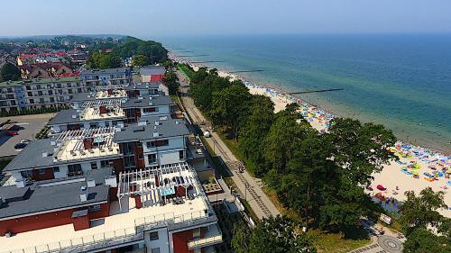 an aerial view of a beach with buildings and the ocean at REWAL Komfortowy apartament przy plaży typu STUDIO in Rewal