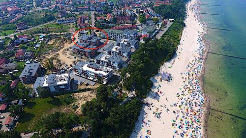 an aerial view of a beach with a red circle at REWAL Komfortowy apartament przy plaży typu STUDIO in Rewal