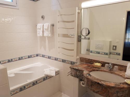 La salle de bains est pourvue d'un lavabo et d'une baignoire. dans l'établissement Hôtel de Charme Brise Marine, à Saint-Jean-Cap-Ferrat