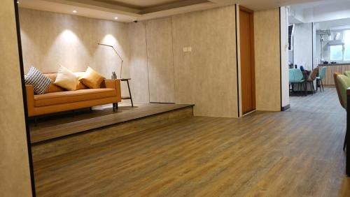a living room with a couch and a table at Homy Inn North Point in Hong Kong