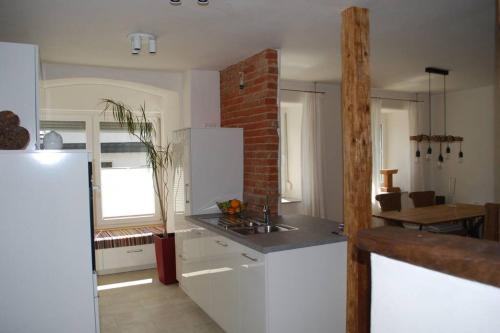 a kitchen with a white refrigerator and a table at Ferienwohnung Roth, Unlingen in Unlingen