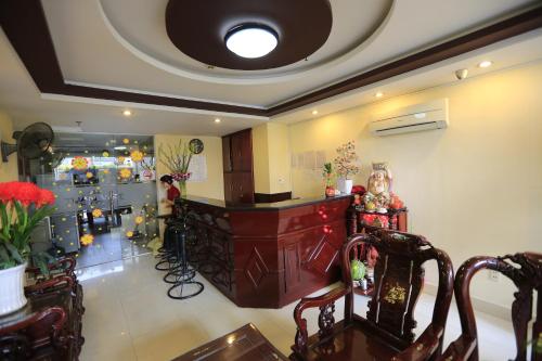 a dining room with a counter and a room with christmas decorations at The Art - Tuan Viet Hotel in Ho Chi Minh City