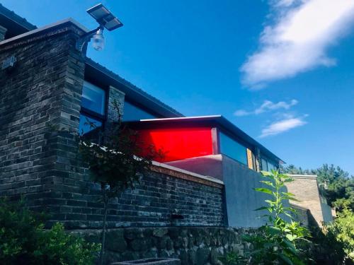 a house with a red window on a brick wall at Home of the Great Wall in Huairou