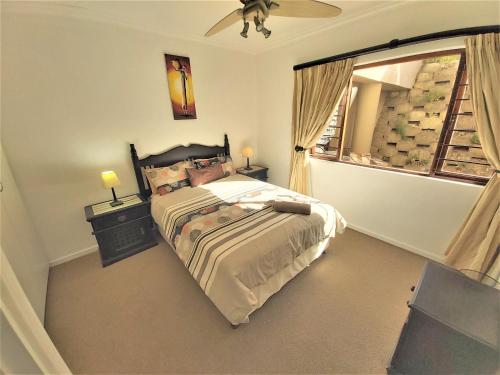 a bedroom with a large bed and a window at Kuta Beach 3 in Ramsgate