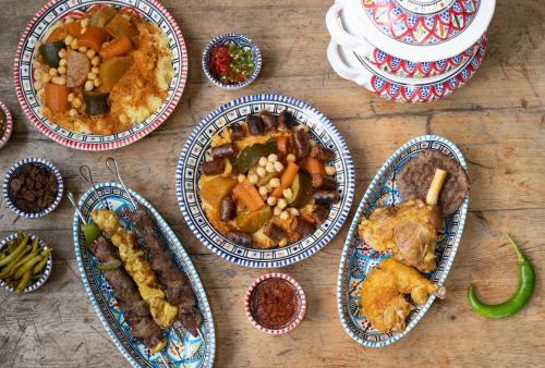 a wooden table with four plates of food on it at Le Bon Moine in Reims