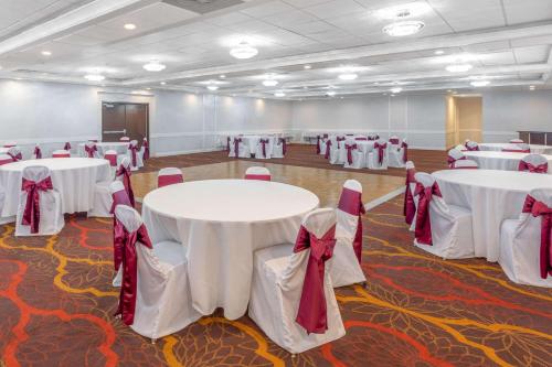 a large room with tables, chairs, and tables at Days Inn and Suites by Wyndham Hammond, IN in Hammond