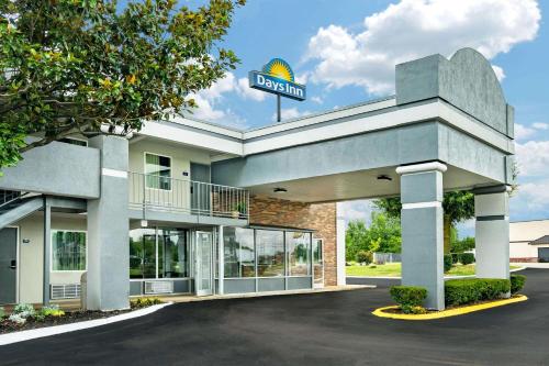 a hotel with a sign on top of a building at Days Inn by Wyndham Clarksville TN in Clarksville