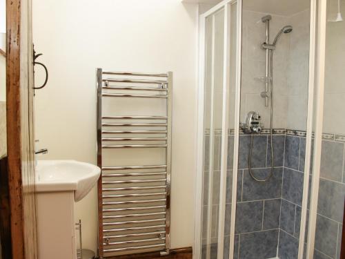 a bathroom with a sink and a shower at Wilstone Cottage in Church Stretton