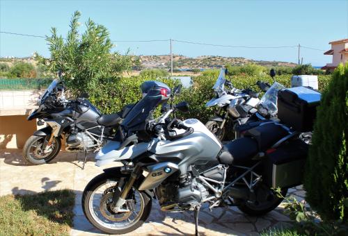a row of motorcycles parked next to each other at Helen's Sounio Apartments in Sounio