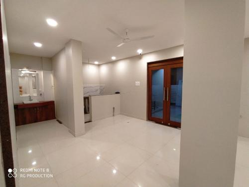 a large white room with a kitchen and a door at The Jawai Gateway in Sheoganj