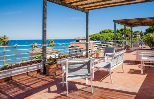 a patio with a view of the ocean at Hotel Moresco in Diano Marina