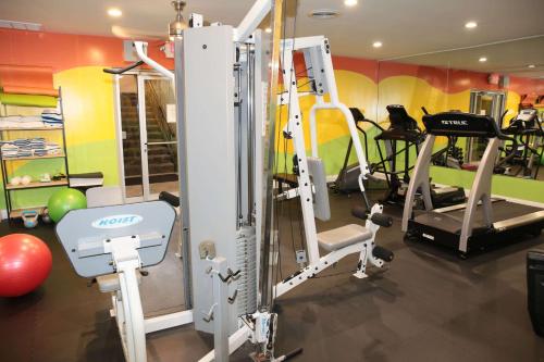 a gym with several tread machines in a room at Quality Inn O'Hare Airport in Schiller Park
