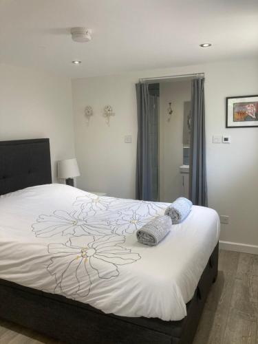 una camera da letto con un grande letto bianco con cuscini sopra di Brand new apartment in Knutsford a Knutsford