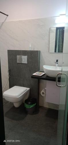 a bathroom with a toilet and a sink at Fantasea in Visakhapatnam