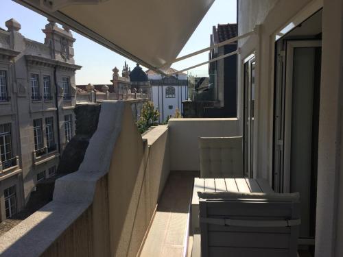a balcony of a building with a bench on it at Central & Charming Clérigos Appartments in Porto
