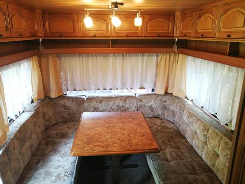 ein Sofa in einem Zimmer mit einem Holztisch in der Unterkunft Őrségi Nomád-Lak Nomád 2 in Kercaszomor