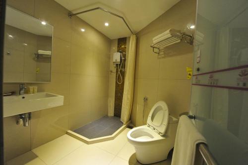 a bathroom with a shower and a toilet and a sink at Milano Hotel in Kluang