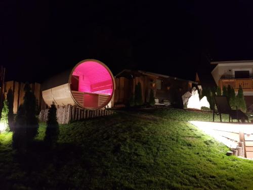 a round mirror on the side of a yard at night at AGRITURISMO La Giasena in Ponte nellʼAlpi