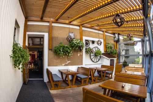 a restaurant with wooden tables and chairs in a building at Hotel Karel IV. in Turnov