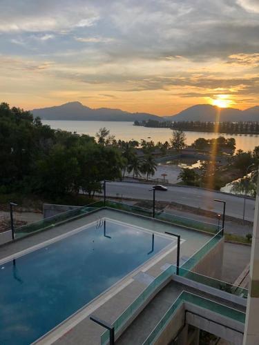 a swimming pool with a view of the water at Marina Heights Seaview Resort 2 in Lumut