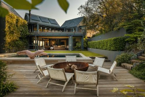 a patio with chairs and a fire pit in front of a house at Spanish Farm Boutique Hotel & Villas in Somerset West