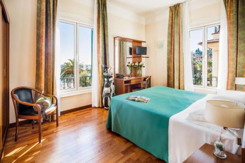 a hotel room with a bed and a window at Hotel Riviera in Rapallo