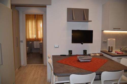 a kitchen and dining room with a table and chairs at Orchidea Marina in Tirrenia