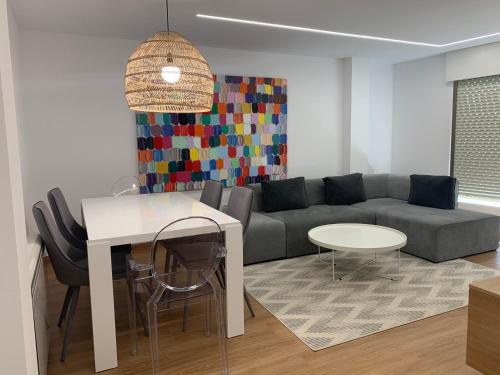 a living room with a couch and a table at Oktheway Pedro Saco Street in Sarria
