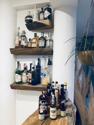 a bunch of bottles on shelves in a room at Black Market Hotel in Ischia