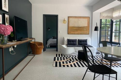 a living room with a couch and a table at Uccle, Pavillon Vert in Brussels