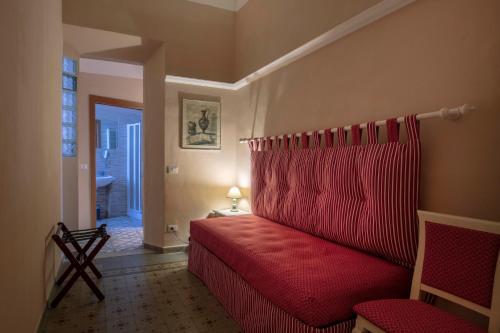 a bedroom with a red bed in a room at La Dimora Delle Terme in Rapolano Terme