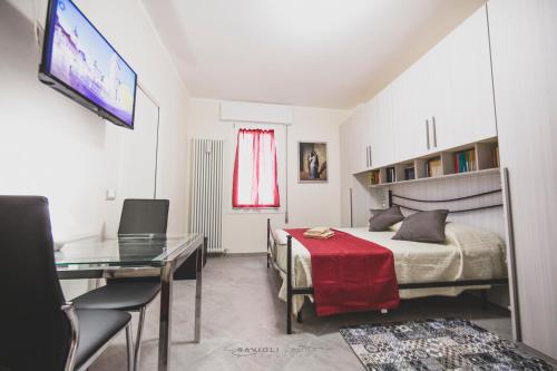 a bedroom with a bed and a table and a desk at ART & BOOKS bed and breakfast in Mantova
