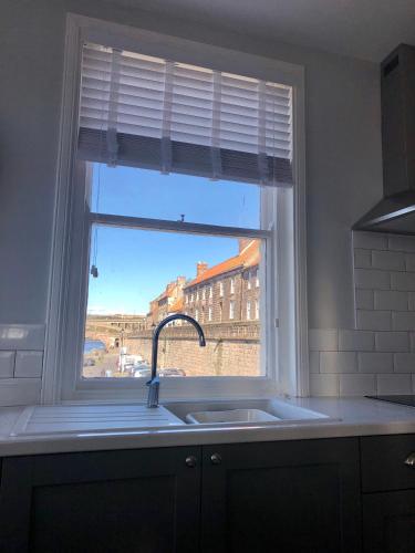 a window in a kitchen with a sink and a sink at The Drawing Office in Berwick-Upon-Tweed