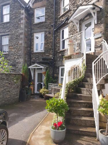 a stone house with stairs and potted plants at 'Mysty' Studio style Winter deal on 3 nights or more Nov to Mar in Windermere