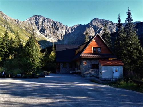 a large building with mountains in the background at Apartmán Elenka in Zuberec