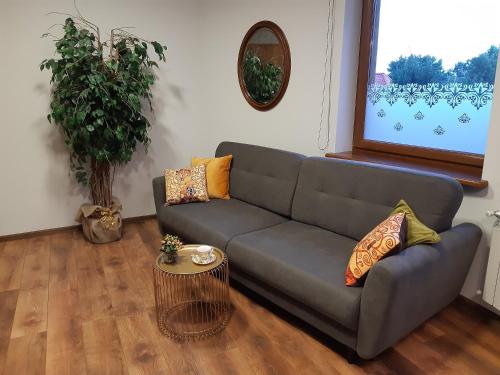 a living room with a couch and a table at SECESJA HOUSE in Oświęcim