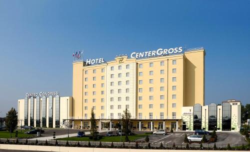 a large hotel with a sign on top of it at Zanhotel Centergross in Bentivoglio