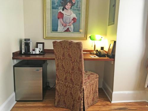 a desk with a chair and a picture on the wall at Morris House Hotel in Philadelphia