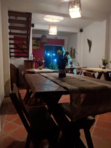a dining room with a table and chairs and a aquarium at Pousada Farol do Patacho in Pôrto de Pedras