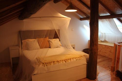 a bedroom with a bed with a canopy at Bosque dos Amieiros in Marco de Canavezes