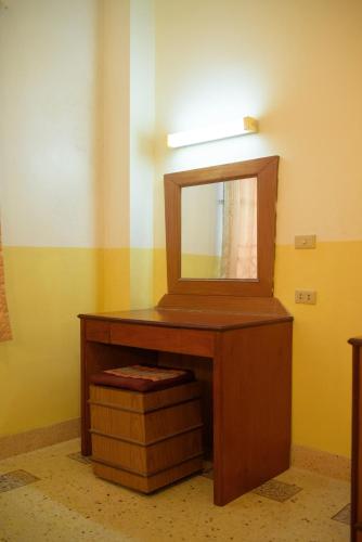 a bathroom with a wooden vanity with a mirror at Kim Jek Cin 2 Hotel - โรงแรมกิมเจ็กซิน2 in Mukdahan