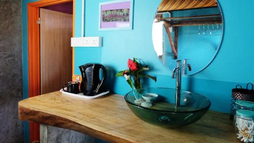 a bathroom counter with a sink and a mirror at The Kasbah Langkawi in Pantai Cenang