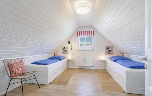 Schlafzimmer im Dachgeschoss mit 2 Betten und einem Stuhl in der Unterkunft 2 Bedroom Gorgeous Home In Zerpenschleuse in Zerpenschleuse