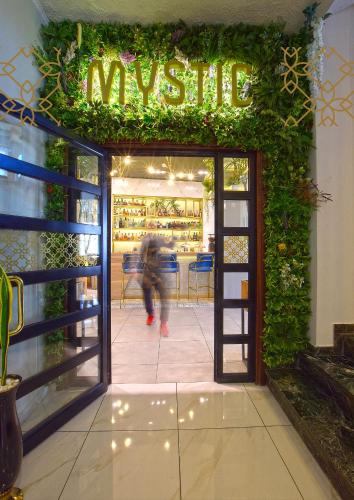 a person walking through the door of a music store at John's Hotel in Chalkida