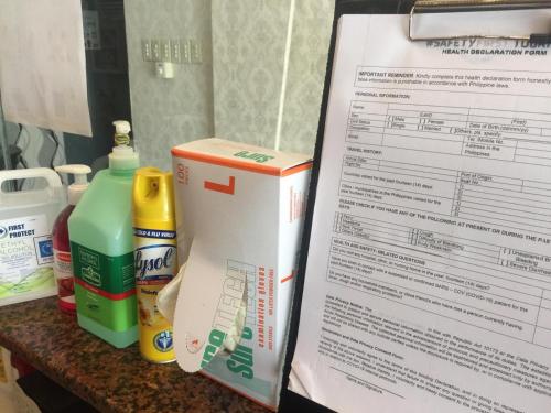 a counter top with a box of bleach and a paper at My Dream Place Hotel - Near Robinsons Mall in Butuan