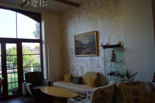 a living room with a couch and a table at Fly inn Hotel Lounge in Machelen