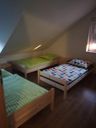 a room with three beds in a attic at Apartament Dobrzeń Wielki in Dobrzeń Wielki