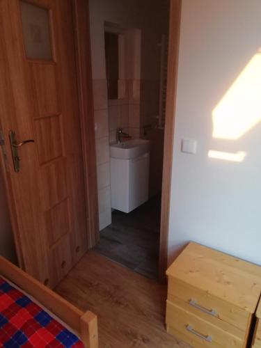 a bathroom with a toilet and a sink in a room at Apartament Dobrzeń Wielki in Dobrzeń Wielki