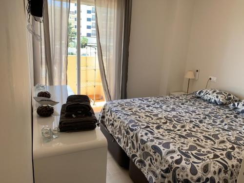 a bedroom with a bed and a window at Apartment on the beach,fuengirola in Fuengirola