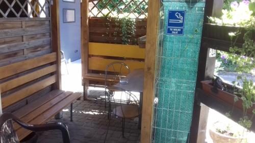 a door to a patio with a table and a bench at Pokoje Gościnne Jaga in Kielce